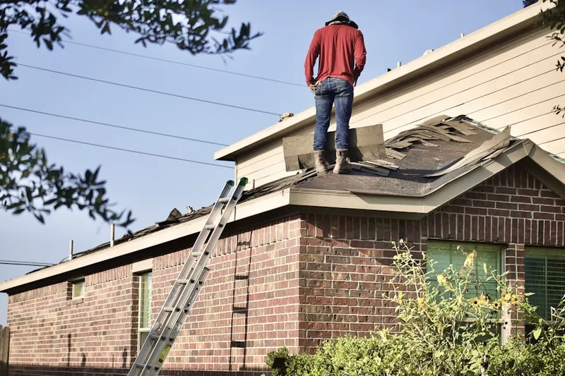 Professional roofer working on a residential roof in Roscoe